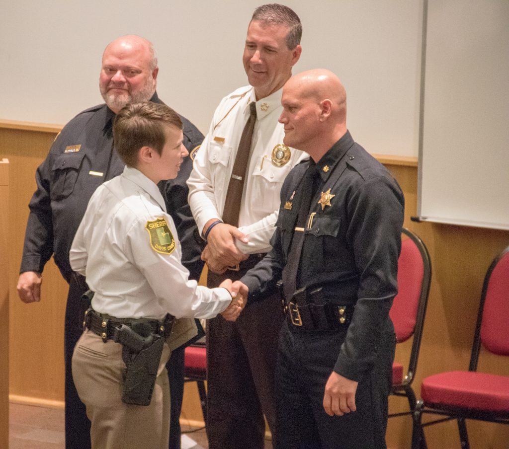 New Davis County deputy shakes hands with Major Stephenson.