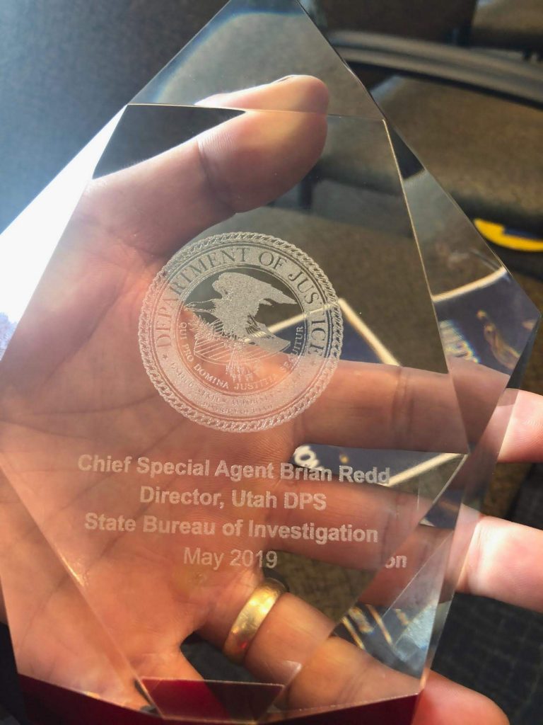 Chief Redd holds the award he received from the US Attorney