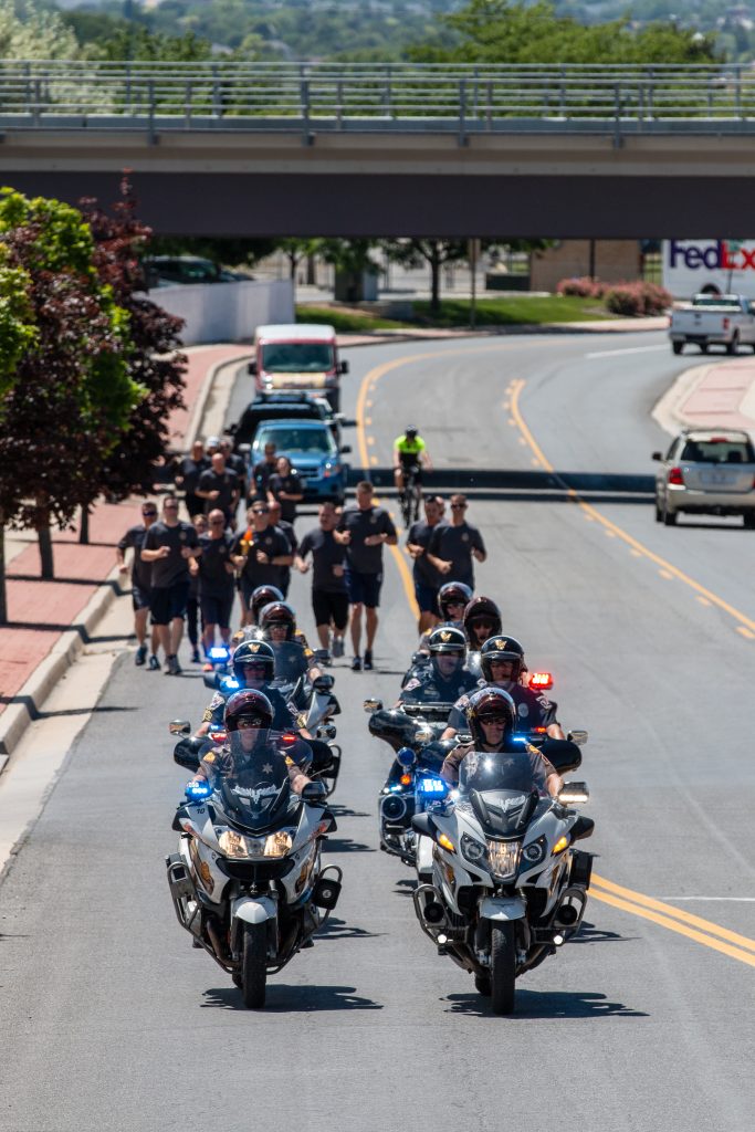 UHP and West Jordan motors lead the way for DPS runners on the Special Olympics Torch Run.