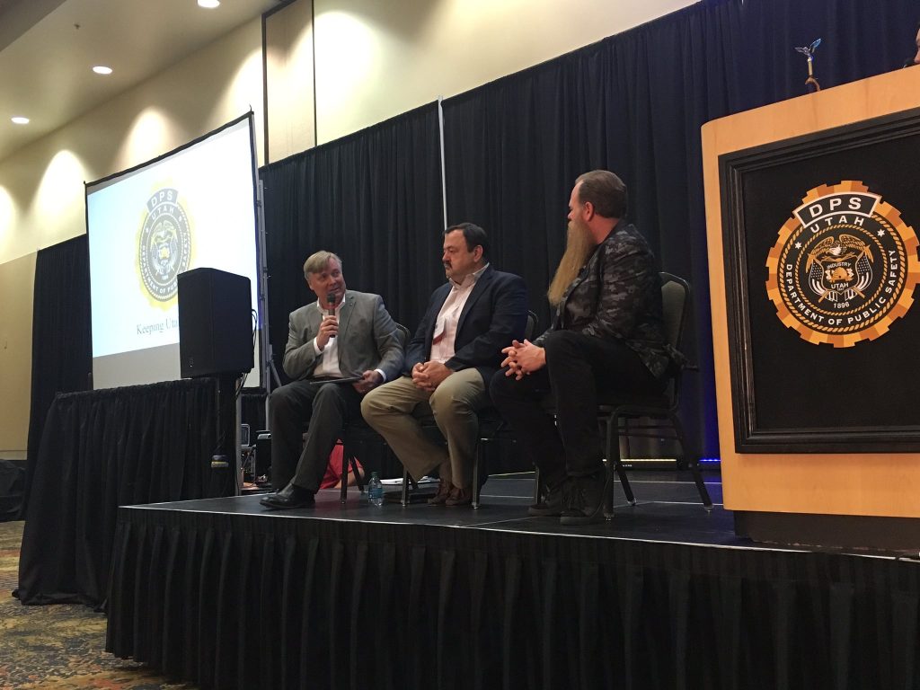 DTS's Mike Hussey, UDOT's Blaine Leonard, and Banjo CEO Damien Patton appear on stage as a panel, discussing artificial intelligence and how it can help save lives.