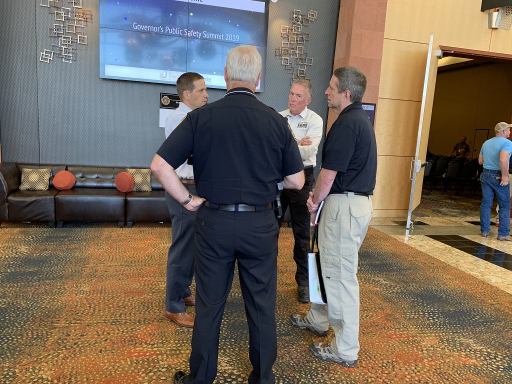 Chief Redd, South Jordan Chief Carr and two other conference attendees meeting the hallway at the convention center.