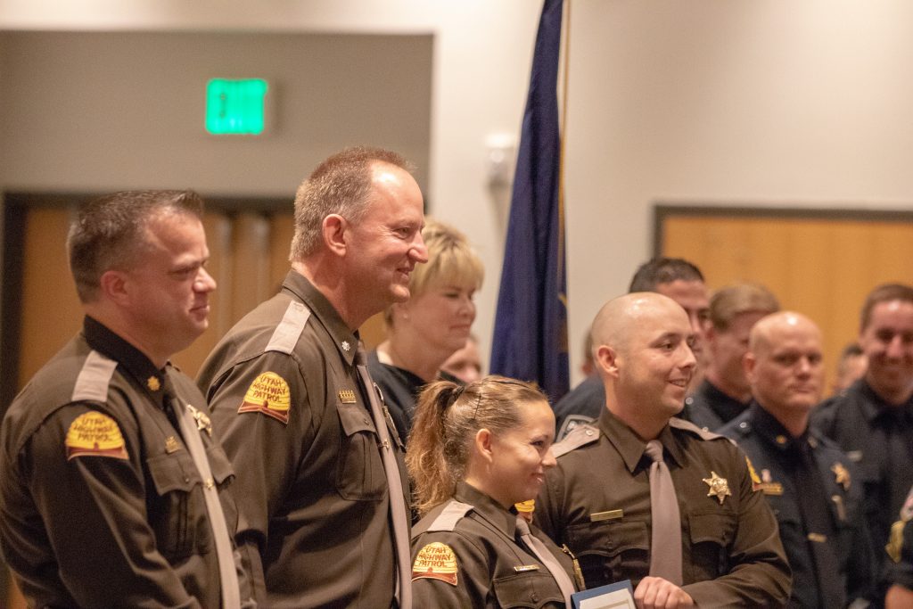 Major Kotter, Lt. Colonel Zesiger stand next to a new trooper and his sister, who is also a trooper, as they hold the law enforcement certficiate.