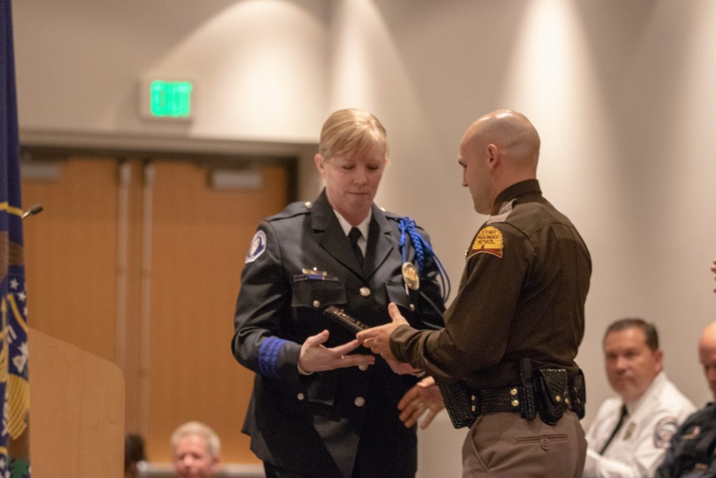 American Fork Police Department Sgt. Jennifer Nakai presents Trooper Alexander McCampbell with the Outstanding Achiever Award.