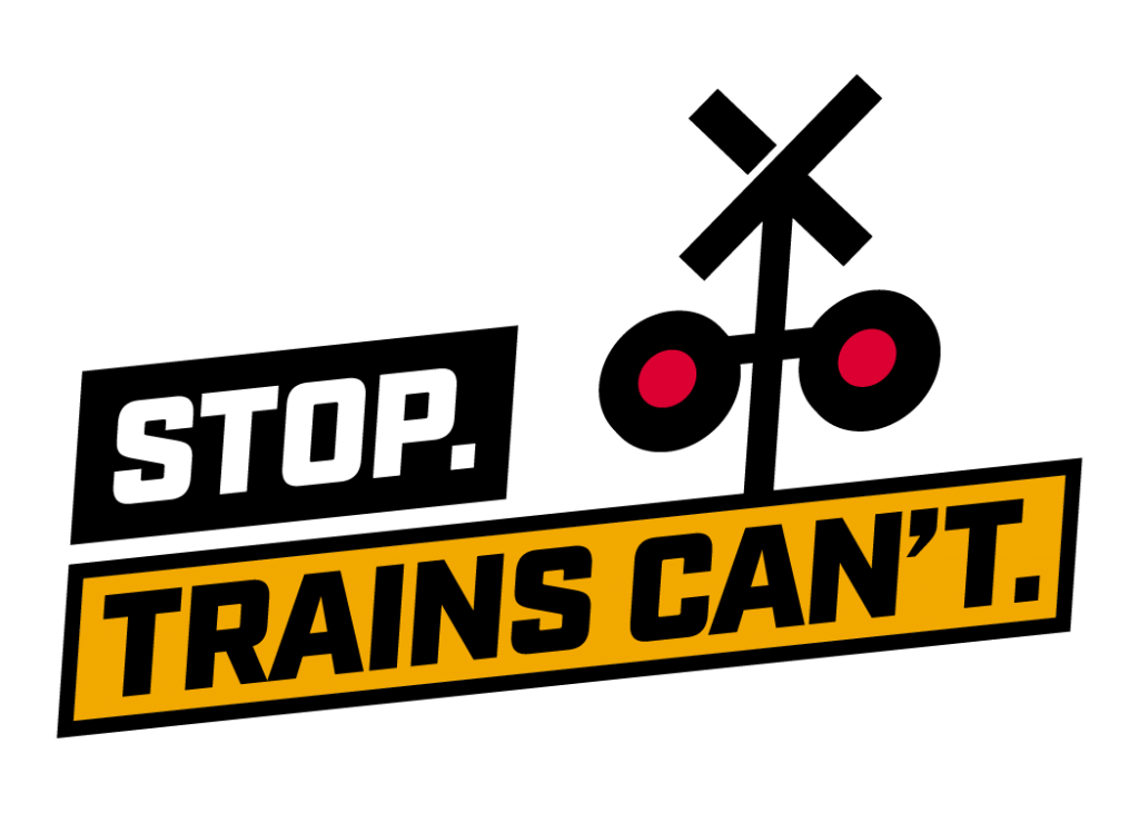Image shows a train track crossing sign animated with the text Stop. Trains Can't.