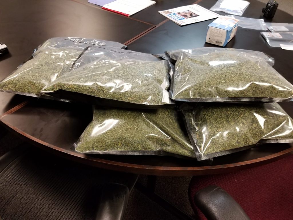 Packages of shredded marijuana are on a table.