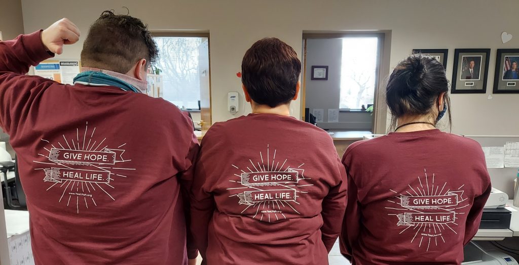Driver License Division employees pose wearing their shirts for the organ donor partnership campaign with Donor Connect.