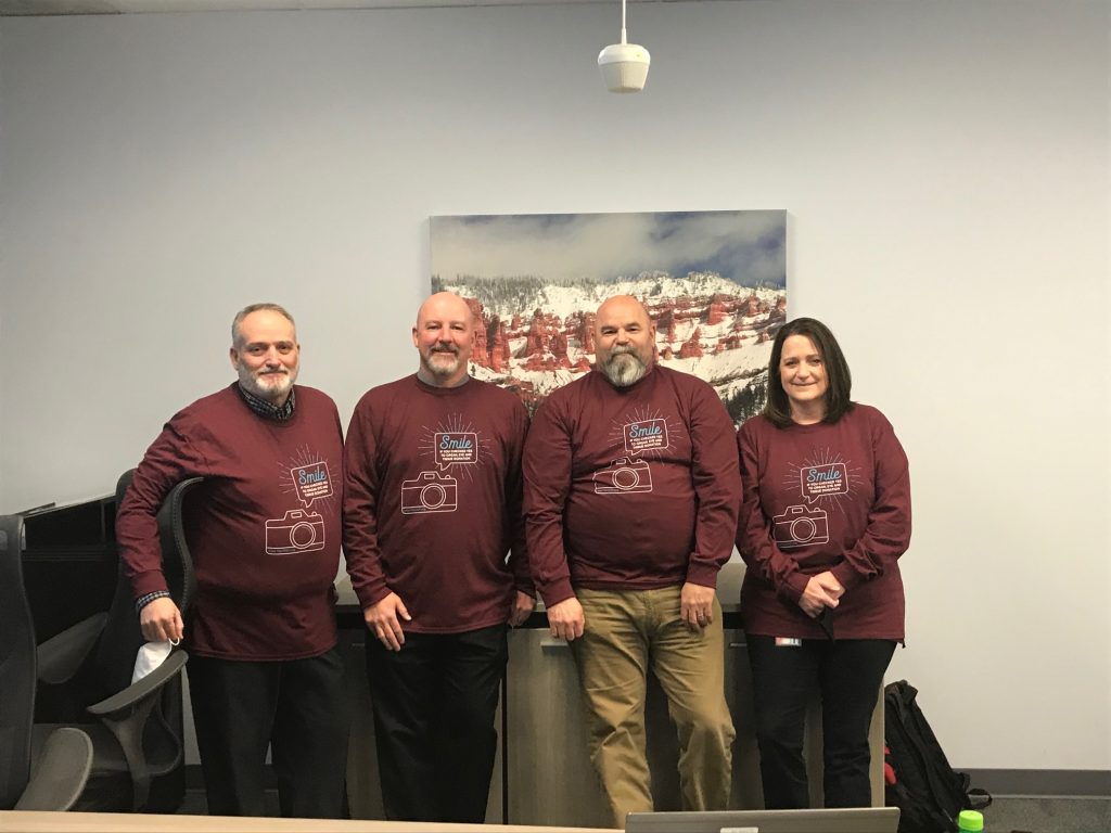 Driver License Division employees pose wearing their shirts for the organ donor partnership campaign with Donor Connect.