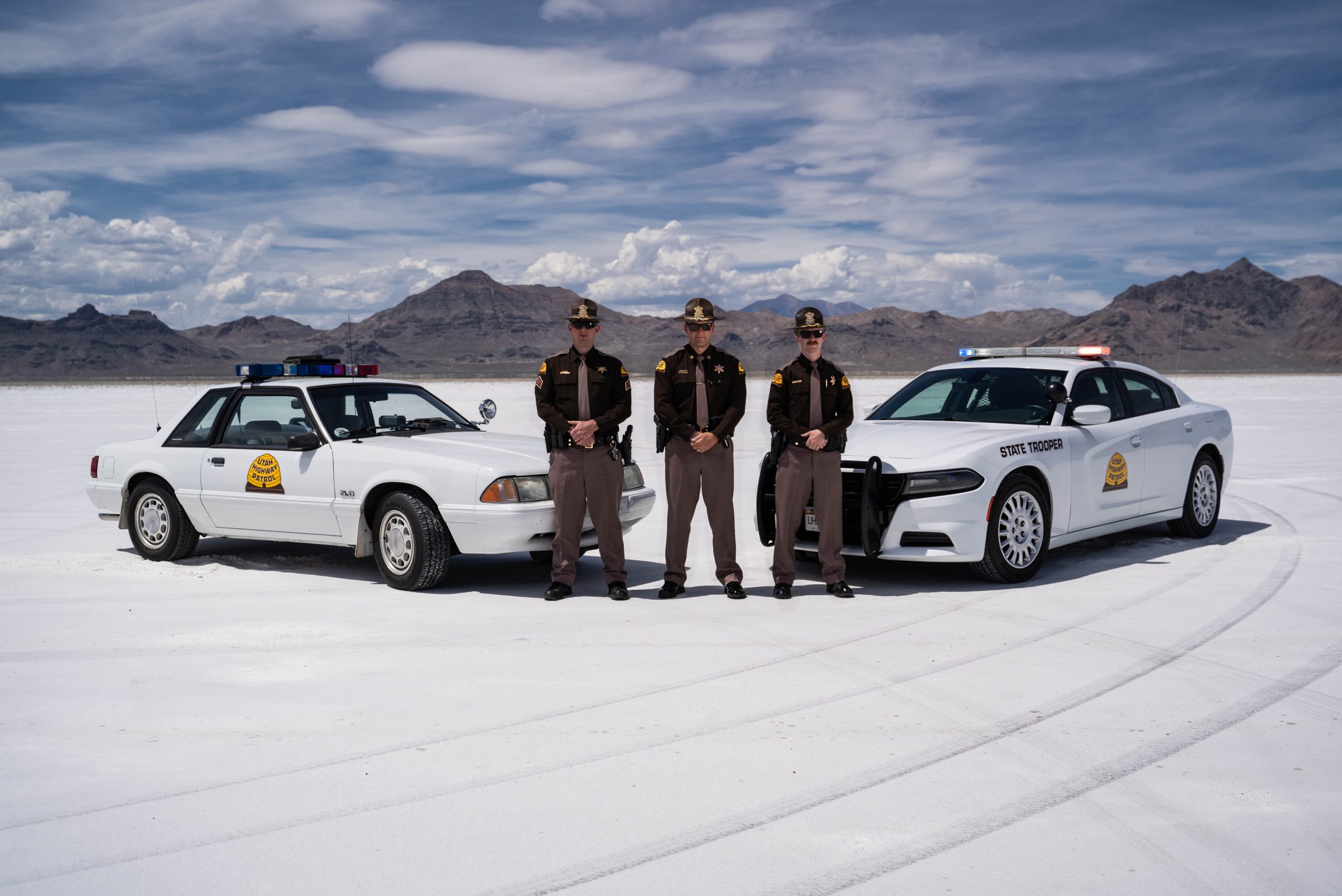 Three UHP Troopers stand by their vehicles on the Salt Flats.
