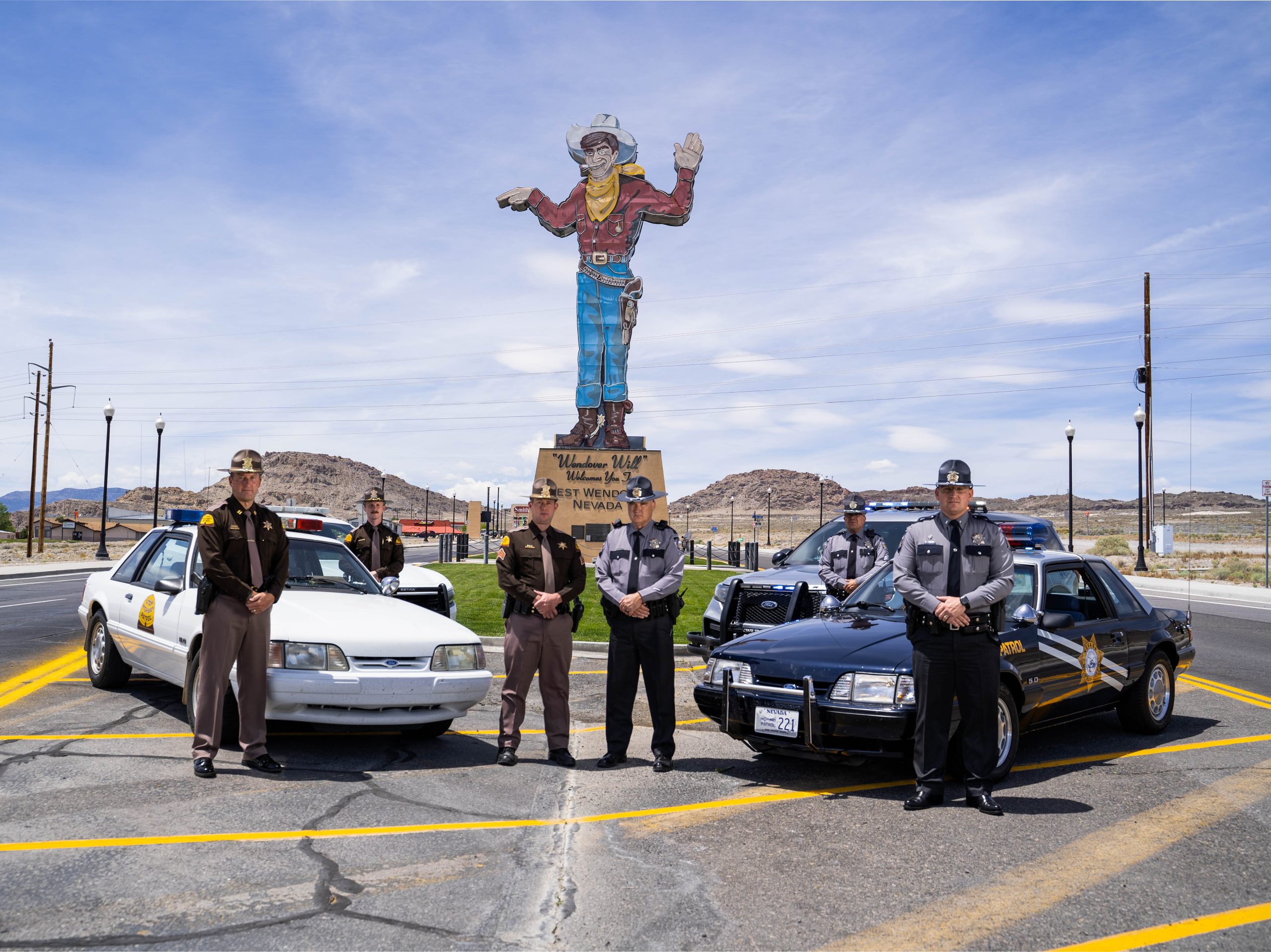 Three UHP Troopers and 3 Nevada Troopers stand by their vehicles near Wendover Will.