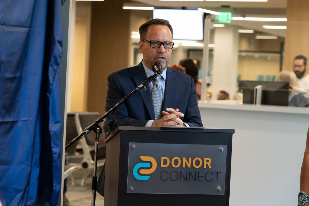 Brady Dransfield from DonorConnect speaks at the podium.